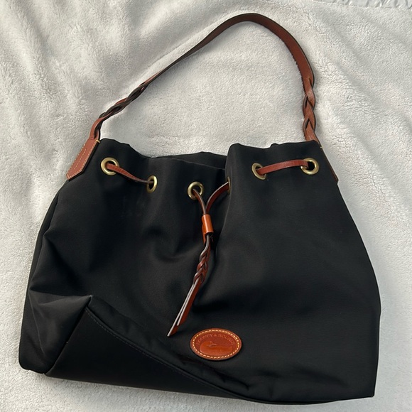 Pre-owned nylon Dooney & Burke black purse. It has a pretty red interior. - Picture 1 of 3